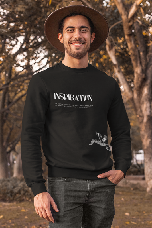 Man wearing a black sweatshirt with 'INSPIRATION' text outdoors.